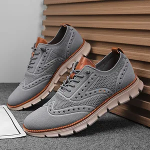 Detailed macro shot of grey flyknit mesh casual shoes with brogue wingtip patterns