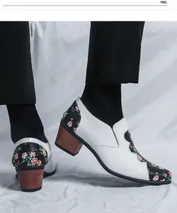 Close-up of men's floral patchwork high heel patent leather shoes with wood grain heel.