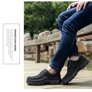 Detailed view of men's black top grain leather outdoor casual shoes on a wooden walkway