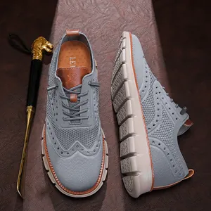 Detailed view of grey fly-knit mesh fabric and brogue patterns on soft leisure shoes