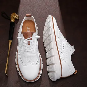 Close-up of white breathable mesh casual shoes with brogue detailing and soft soles.