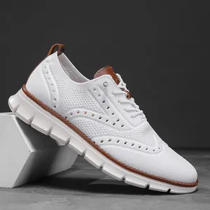 Detail of white flyknit mesh sneaker with brown leather accents and textured sole