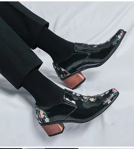 Detail of men's floral patchwork patent leather shoes with wood grain block heel.