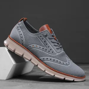 Detail of breathable grey fly-knit fabric and decorative brogue stitching
