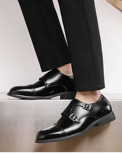 Detailed close-up of men's black leather double monk strap shoes with brogue detailing