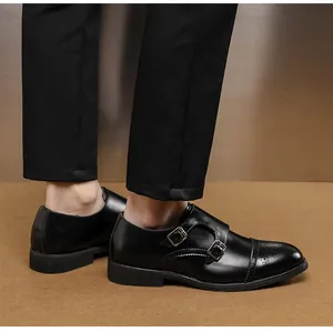 Detailed side view of men's black leather monk strap dress shoes with double buckles