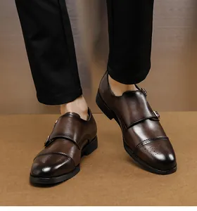 Close-up of brown double monk strap leather shoes with brogue toe cap detail