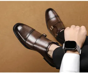 Close-up of brown leather monk strap shoes with brogue detailing and double buckles