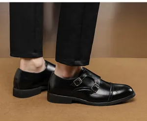Close-up detail of mens black leather double buckle monk strap shoes with brogue toe