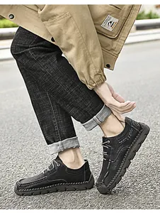 Detail view of men's black microfiber casual shoes with distinctive handmade stitching.