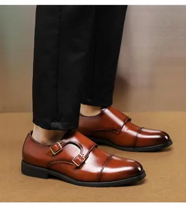 Elegant brown leather double monk strap shoes with gold buckles shown on model