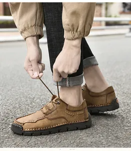 Close-up of brown microfiber hand-stitched casual shoes being laced up outdoors on asphalt