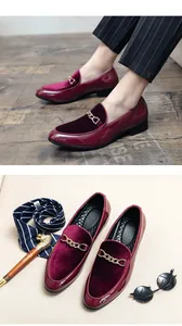 Detailed view of burgundy patent leather and velvet loafers with gold chain buckle