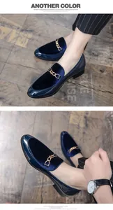 Close-up of blue velvet loafers with gold chain and patent leather accents