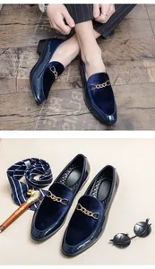 Close-up detail of navy blue velvet loafers for men with gold buckle and patent leather