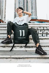 Detailed view of breathable fly-knit blade running shoes in a street style outdoor setting.