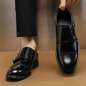 Classic black monk strap loafers for men featuring elegant decorative brogue toe detailing