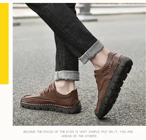 Detail view of brown men's casual shoes with hand-stitched detailing on a model
