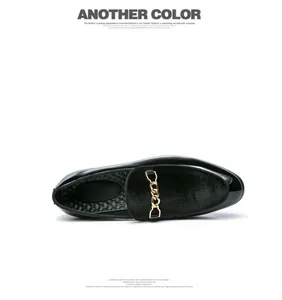 Top-down view of black velvet men's slip-on loafer with gold chain buckle detail