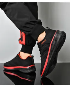 Vue détaillée de baskets de sport noires et rouges pour hommes en maille filet.