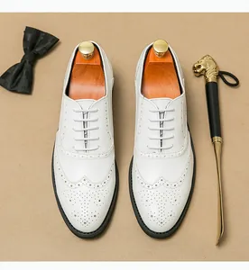 Top view detail of elegant white men's leather brogue dress shoes for weddings