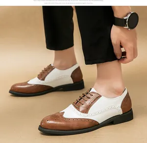 Detailed close-up of men's two-tone wingtip brogue shoes in brown and white leather.