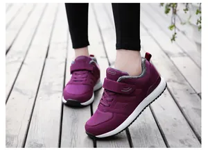 Detailed view of purple winter walking shoes with warm grey fur lining and velcro strap