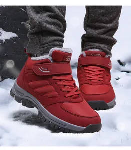 Red fleece-lined high-top winter boots for seniors shown in a snowy outdoor scene.
