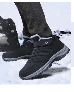 Detail of black winter fleece-lined high-top elderly hiking shoes on outdoor snow