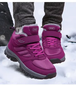 Close-up detail of purple high-top fleece-lined winter walking shoes shown on snow