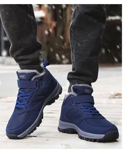 Detailed view of navy blue high-top winter snow boots with warm fur lining.