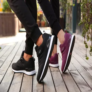 Detail view of breathable elderly walking shoes in black and plum purple with Velcro straps