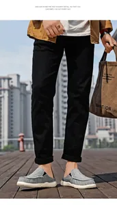 Close-up of men's casual grey breathable canvas mules shown in an outdoor urban setting