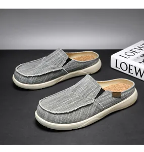 Side view of grey canvas men's casual mules with slip-on design and cork insole