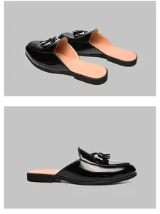 Close-up of black patent leather men's tassel loafers with a high-shine glossy finish
