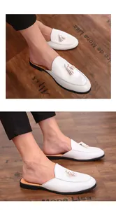 Detail shot of men's white tassel leather loafers with a minimalist slip-on design