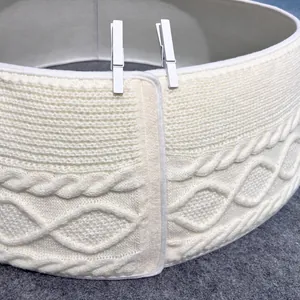 Close-up detail of a white cable-knit Christmas tree collar showing elegant texture