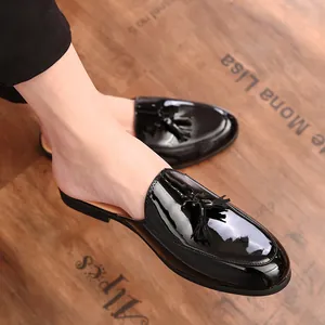 Classic black patent leather men's tassel loafers in a stylish backless mule style