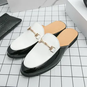 Fashionable men's black and white patent leather mules with gold metal horsebit detail
