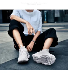Close-up van witte ademende flyknit mesh sneakers in een stedelijke straatomgeving