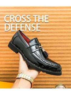 Detail view of stylish shiny black leather loafers for men featuring elegant gold tassels
