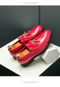 Detail shot of men's red patent leather loafers featuring gold tassels and EVA sole