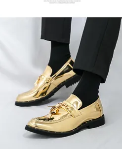 Detailed view of men's gold glossy tassel loafers featuring a premium metallic finish