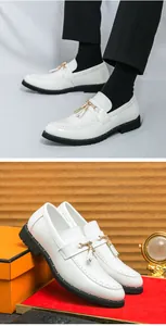 Macro view showing the detailed texture and gold tassel of men's white glossy loafers