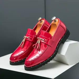 Premium men's shiny red patent leather loafers with tassel detail and golden buckle