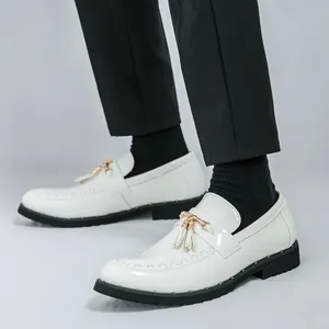 Men's white patent leather tassel loafers with gold hardware and black soles