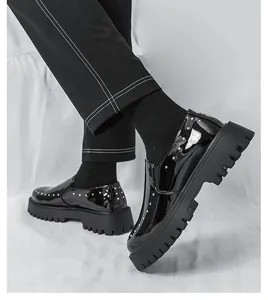 Detailansicht von schwarzen Lacklederslippern für Herren mit Goldnieten und dicker Sohle