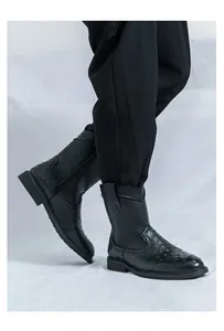 Close-up detail of men's retro black knight boots with ostrich skin pattern texture