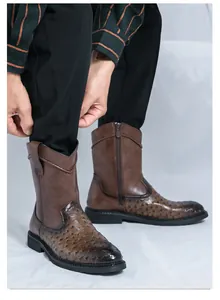 Close-up of retro brown men's cowboy boots with ostrich texture and side zipper.