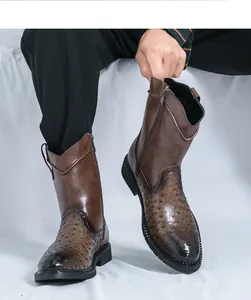 Detail view of brown men's cowboy boots featuring ostrich skin texture and side zipper